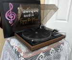 Dual 504 from the left with the dust cover raised, platter, tonearm and cartridge visible on the black deck inside the walnut plinth