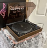 Dual 606 from the left with the cover raised, platter, tonearm and blue cartridge on the black deck in its walnut-finish plinth