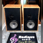 Dynaco A-35 speakers in custom cherry cabinets, grilles off, showing black baffles with a large woofer below a recessed dome tweeter