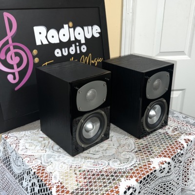 Angled view of the Energy C-50 pair showing the black ash side panels and gloss black front baffles with grey tweeter plates