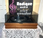 Garrard Synchro-Lab 65B turntable on its wood base with the smoked dust cover closed, seen straight on from the front