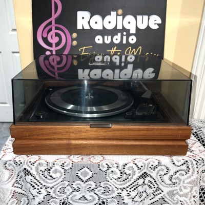 Garrard Synchro-Lab 65B turntable on its wood base with the smoked dust cover closed, seen straight on from the front