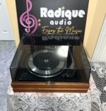 Garrard Synchro-Lab 65B turntable from a high front angle, looking down through the closed dust cover at the platter and tonearm