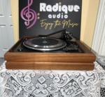 Garrard Synchro-Lab 65B turntable with the dust cover off, straight-on view of the platter and tonearm sitting on the wood base