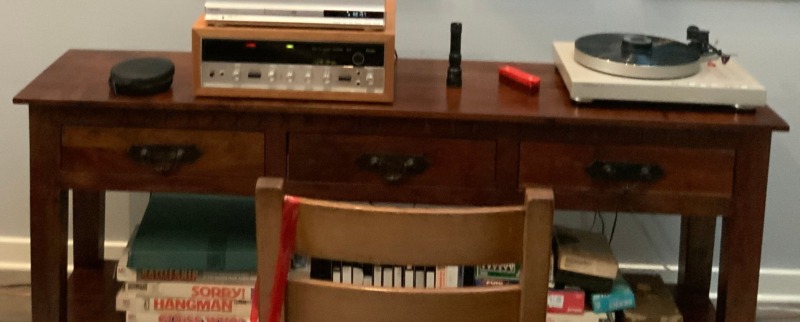 Greg W.’s Sansui receiver and turntable on a wood console in Texas