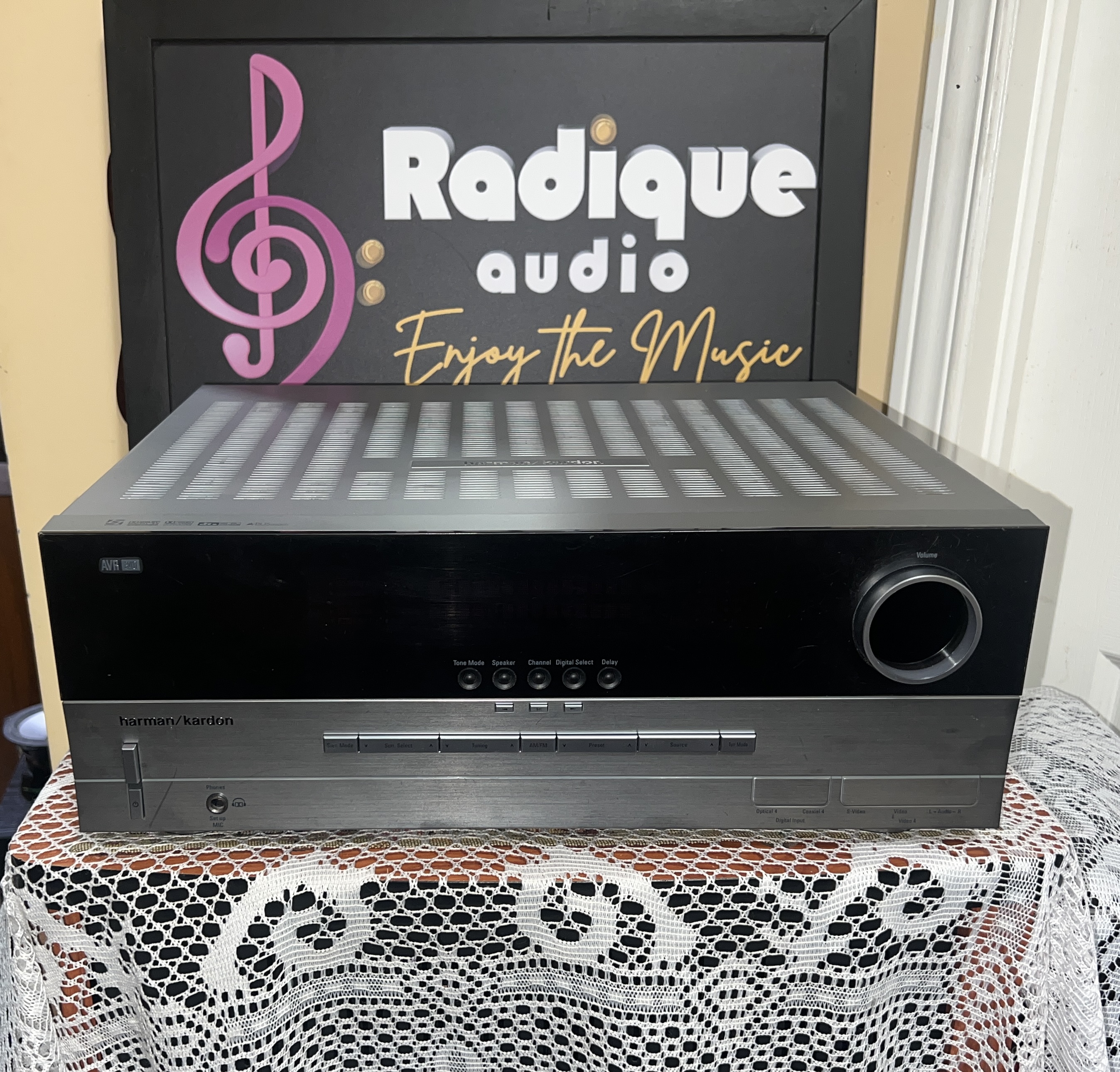 Harman-Kardon-AVR-340-AV-Receiver-Silver-AS-IS-Front Harman Kardon AVR 340 AV receiver with a silver cabinet and gloss black front panel, large volume knob at the right and a row of buttons along the bottom