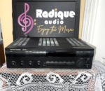 Harman Kardon HK3500 stereo receiver in black, front panel with preset and function buttons, bass, treble and balance knobs and a large volume dial