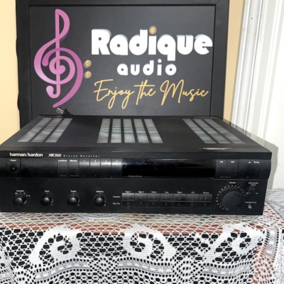 Harman Kardon HK3500 stereo receiver in black, front panel with preset and function buttons, bass, treble and balance knobs and a large volume dial