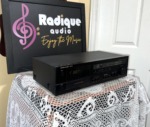 Harman Kardon TD212 cassette deck from the left at an angle, black case with cassette door and front panel controls