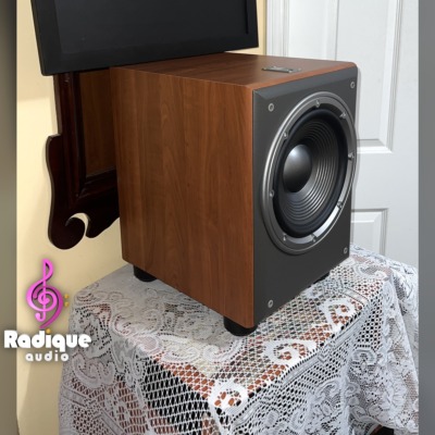 JBL Northridge E150P subwoofer at an angle, cherry side panel and the exposed 10 inch driver on the front baffle