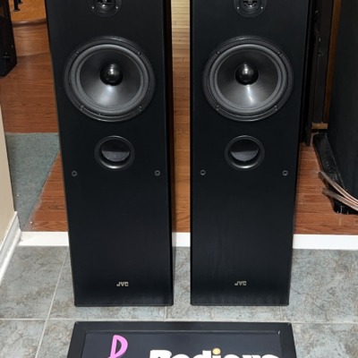 Pair of JVC SP-5500 tower speakers in black woodgrain, grilles off, showing the dome tweeter, large woofer and front bass port