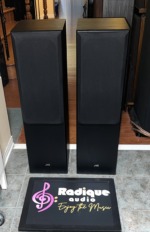 JVC SP-5500 floorstanding speakers with black cloth grilles fitted and the JVC logo on the lower front panel