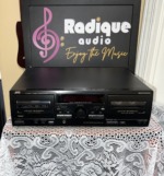 JVC TD-W254BK double cassette deck, black front panel with two auto-reverse tape wells, a dark display window and a centre knob