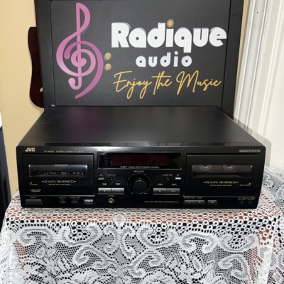 JVC TD-W254BK double cassette deck, black front panel with two auto-reverse tape wells, a dark display window and a centre knob