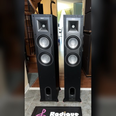 Klipsch KF-26 Icon towers — front view with grilles off, Tractrix horn and dual woofers visible