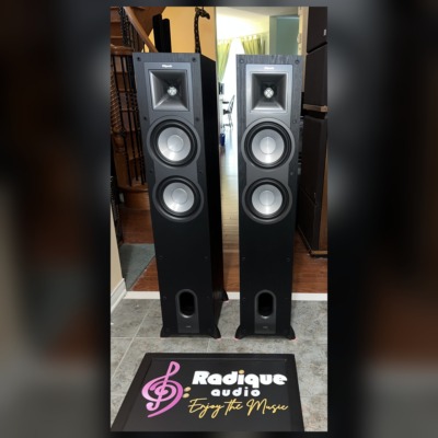 Klipsch KF-26 Icon towers — front view with grilles off, Tractrix horn and dual woofers visible