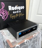 Marantz 112 tuner seen from the right, black vented case and silver front panel with the lit blue dial and Gyro-Touch wheel