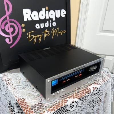 Marantz 112 tuner seen from the right, black vented case and silver front panel with the lit blue dial and Gyro-Touch wheel
