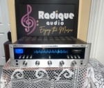 Marantz 2235 stereo receiver, silver faceplate with blue-lit tuning dial and tuning meter, a row of toggle switches and rotary tone and volume knobs