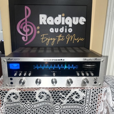 Marantz 2235 stereo receiver, silver faceplate with blue-lit tuning dial and tuning meter, a row of toggle switches and rotary tone and volume knobs