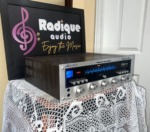 Marantz 2235 receiver from the left front corner, wood-grain cabinet side with the blue-lit dial and silver control knobs