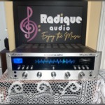 Marantz 2235 stereo receiver, silver faceplate with blue-lit tuning dial and tuning meter, a row of toggle switches and rotary tone and volume knobs