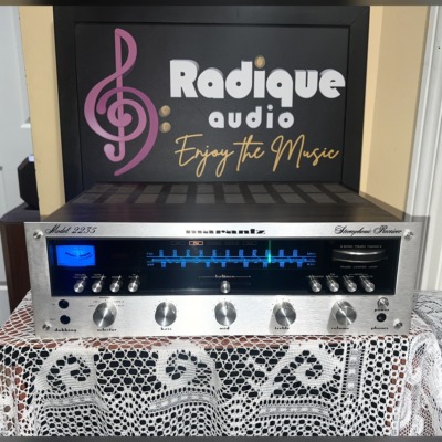 Marantz 2235 stereo receiver, silver faceplate with blue-lit tuning dial and tuning meter, a row of toggle switches and rotary tone and volume knobs