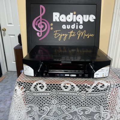 Marantz NR1510 slim AV receiver in black, front panel with display, input and volume knobs and the original feature stickers still on