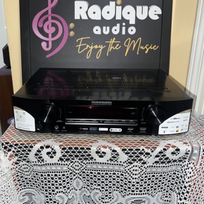 Marantz NR1510 slim AV receiver in black, front panel with display, input and volume knobs and the original feature stickers still on