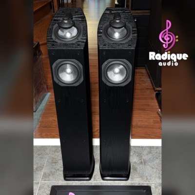 Pair of Mirage OMNI 350 tower speakers in black ash, grilles off, showing the omnipolar tweeters and woofers