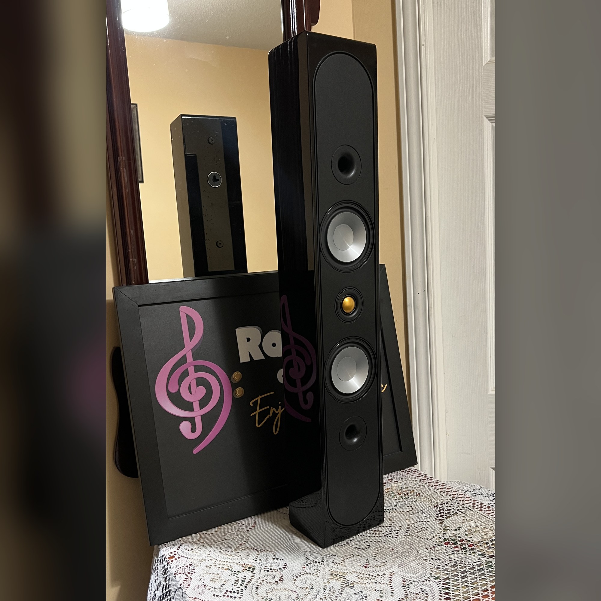 Monitor-Audio-Radius-250HD-LCR-Speakers-Black-Gloss-1-Thumb Monitor Audio Radius 250HD speakers in black gloss standing upright, grille off to show twin silver bass drivers and gold dome tweeter