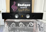 Second Monitor Audio Radius 250HD laid horizontal, front baffle with twin silver drivers, gold tweeter and two small ports