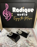 Monitor Audio Radius 90 wall brackets, a pair of black L-shaped arms each topped with a silver swivel ball joint and speaker mounting plate