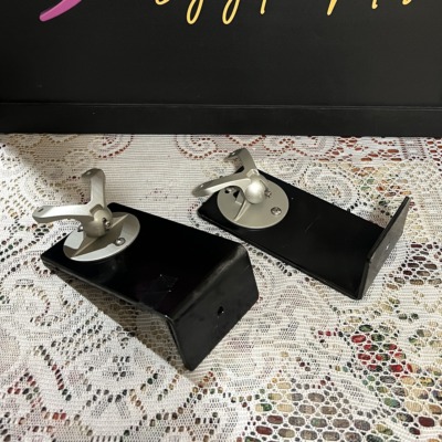 Monitor Audio Radius 90 wall brackets, a pair of black L-shaped arms each topped with a silver swivel ball joint and speaker mounting plate