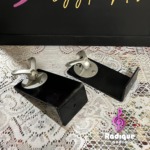Monitor Audio Radius 90 wall brackets, a pair of black L-shaped arms each topped with a silver swivel ball joint and speaker mounting plate