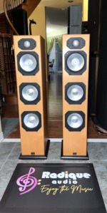 Monitor Audio Silver S8 floorstanding speakers in Warm Beech veneer, grilles off to show the gold dome tweeter and three silver C-CAM cones