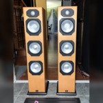 Monitor Audio Silver S8 floorstanding speakers in Warm Beech veneer, grilles off to show the gold dome tweeter and three silver C-CAM cones