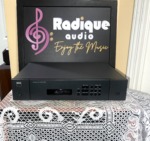 NAD 513 compact disc player in charcoal grey, three-disc display window, play, stop and open buttons and skip and scan keys