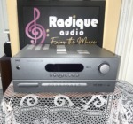 NAD T 753 AV surround sound receiver in silver, front panel with a wide black display window, large volume knob and a row of input buttons