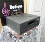 NAD T 753 receiver seen from the left front corner, showing its silver casing, vented top cover and display window