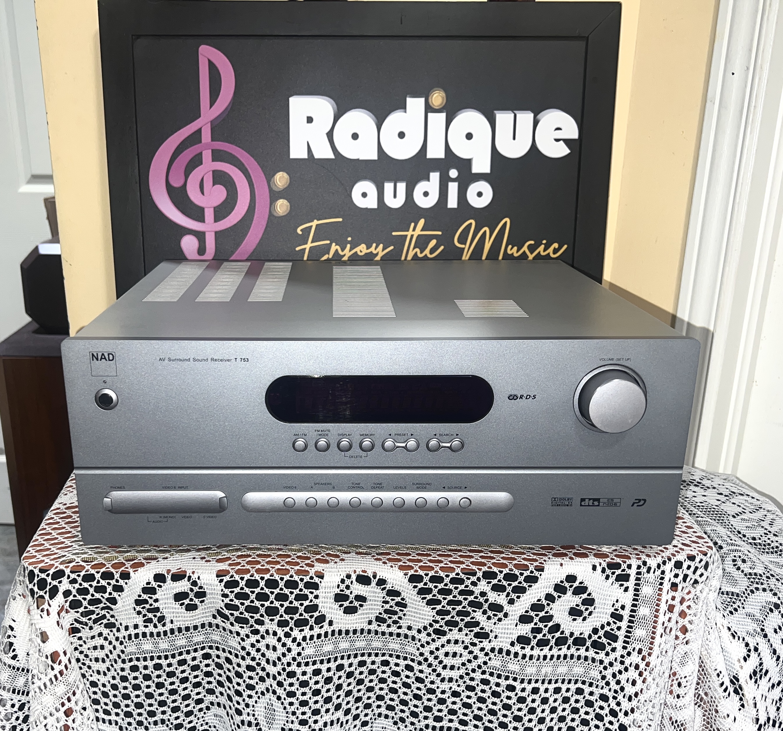 NAD-T-753-AV-Surround-Sound-Receiver-Front NAD T 753 AV surround sound receiver in silver, front panel with a wide black display window, large volume knob and a row of input buttons