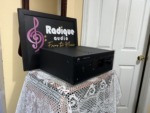 NAD T 757 receiver seen from a front angle on the lace-covered table by the Radique backdrop