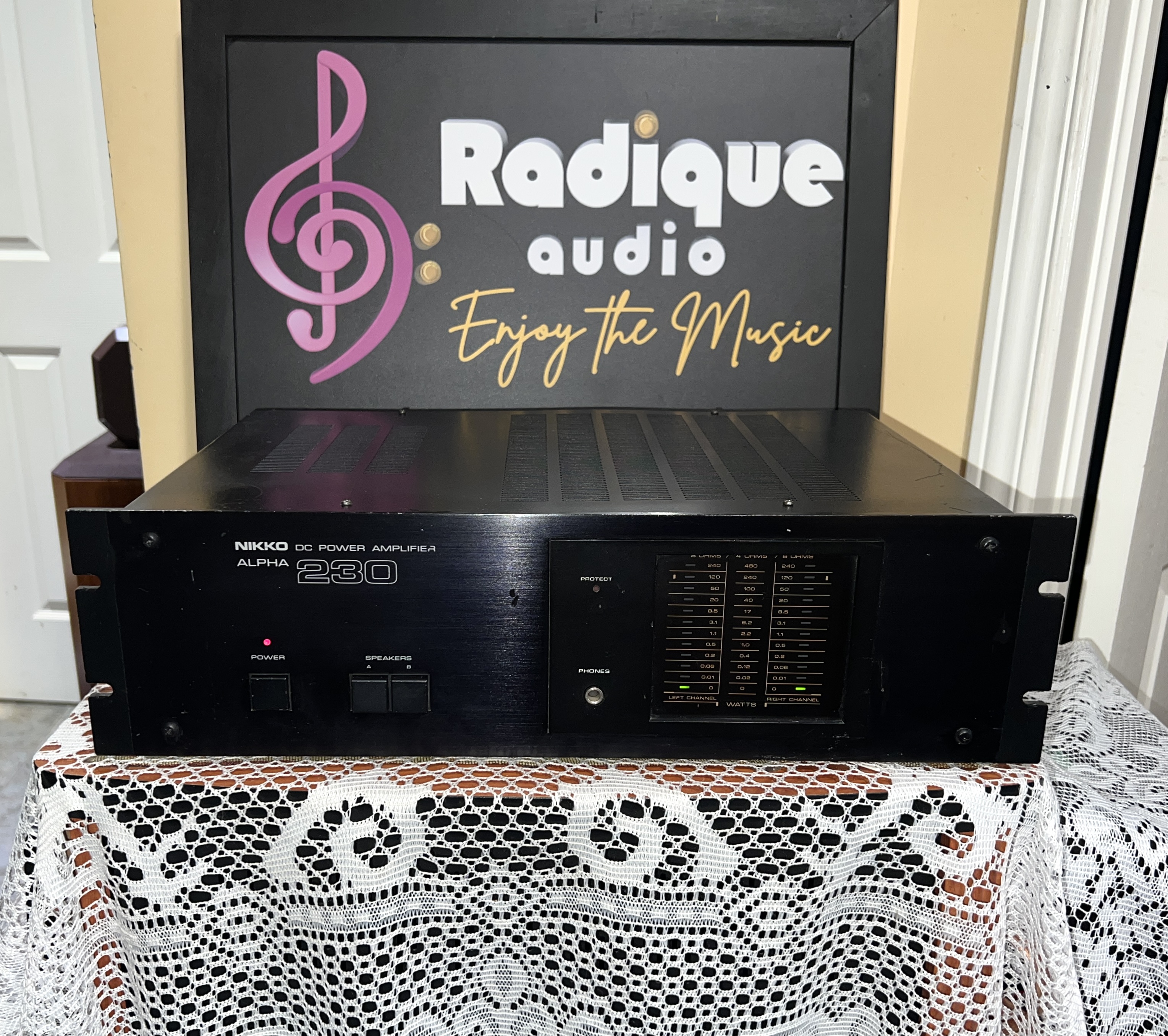 Nikko-Alpha-230-Stereo-Power-Amplifier-Front Nikko Alpha 230 stereo power amplifier in black, brushed faceplate with rack-mount ears, protect light and a column of output level LEDs