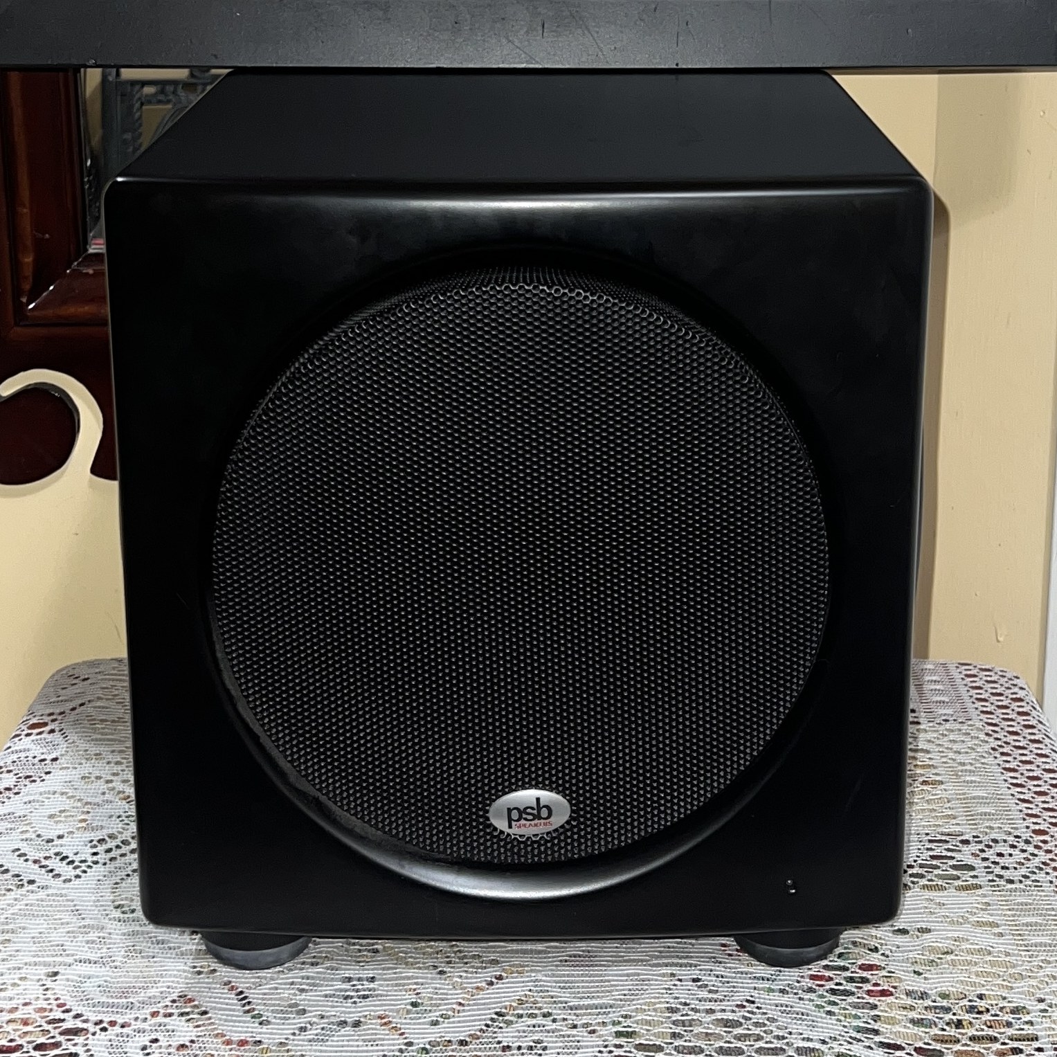 PSB-SubSeries-HD10-Powered-Subwoofer-Front-Thumb PSB SubSeries HD10 powered subwoofer front view, compact satin black cabinet with a black mesh grille over the front driver