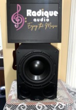 Paradigm DSP-3100 v.2 powered subwoofer, grille off, showing the large black woofer and the twin front ports