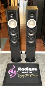 Pair of black Paradigm Monitor 7 v.6 tower speakers, grilles off, showing the tweeter, light-coloured midrange cone and twin black woofers