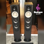 Pair of black Paradigm Monitor 7 v.6 tower speakers, grilles off, showing the tweeter, light-coloured midrange cone and twin black woofers