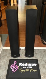 Paradigm Monitor 7 v.6 floorstanding speakers with their black cloth grilles fitted, standing side by side on a tile floor