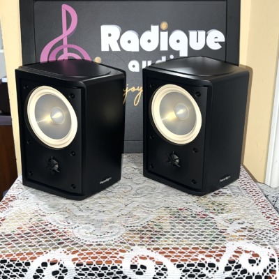 Paradigm Monitor ADP-190 v.6 surround speakers, grilles off, satin black cabinets with cream woofer cones above small tweeters
