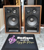 Pioneer CS-77 pair with grilles off: black baffles, each with a large woofer, a midrange cone and a tweeter above, and a slot port at the base, in walnut cabinets
